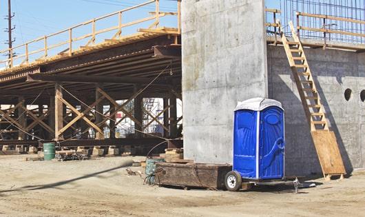 multiple portable restrooms arranged at a busy job site